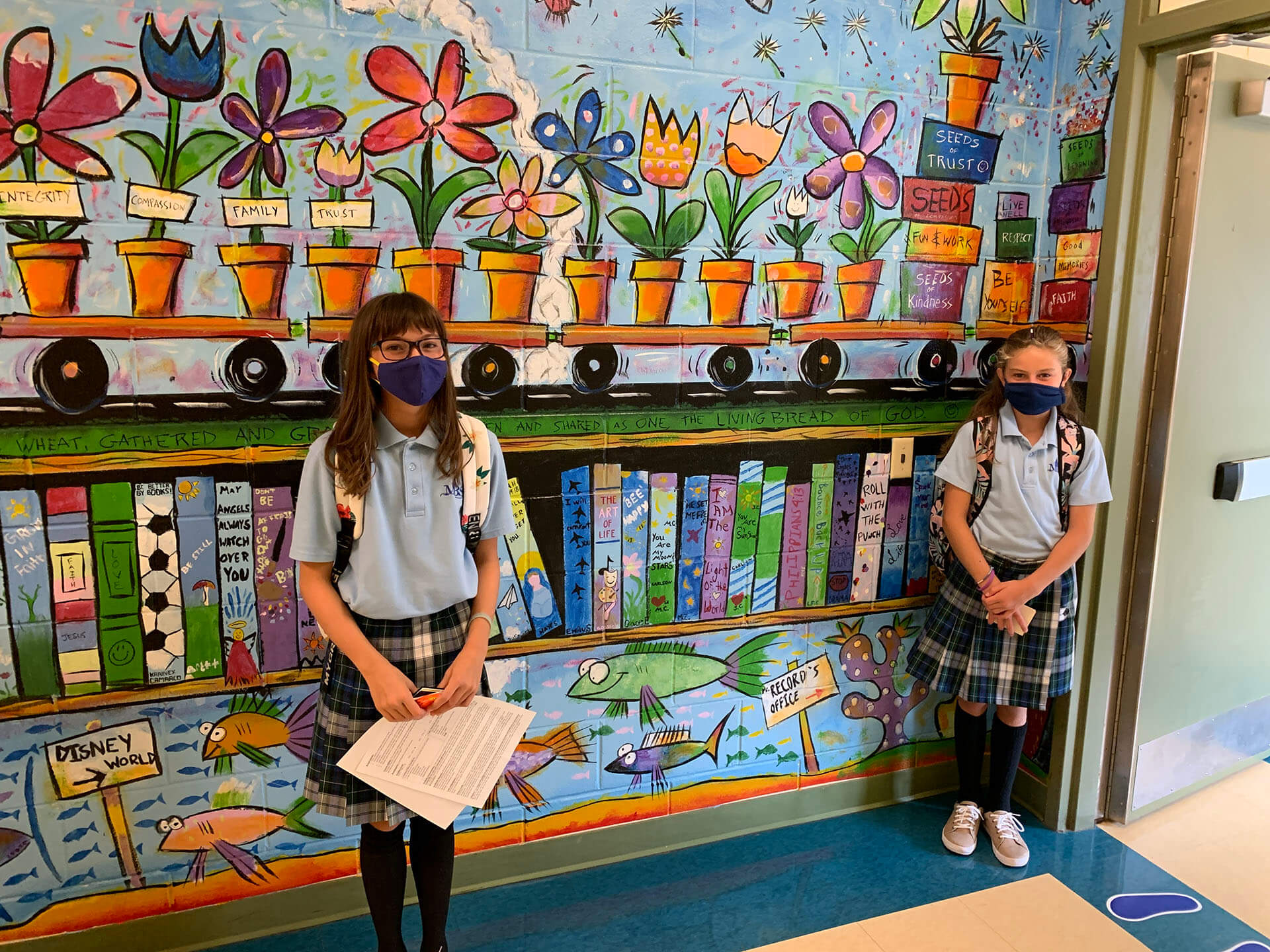 two-kids-in-hallway-wearing-masks